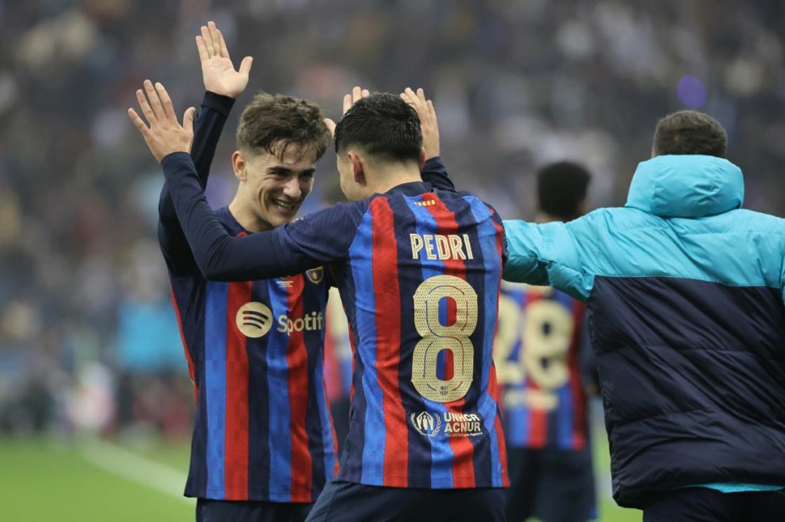 Barcelona midfielder Pedri celebrates with Gavi after scoring his team's third goal during the Spanish Super Cup final