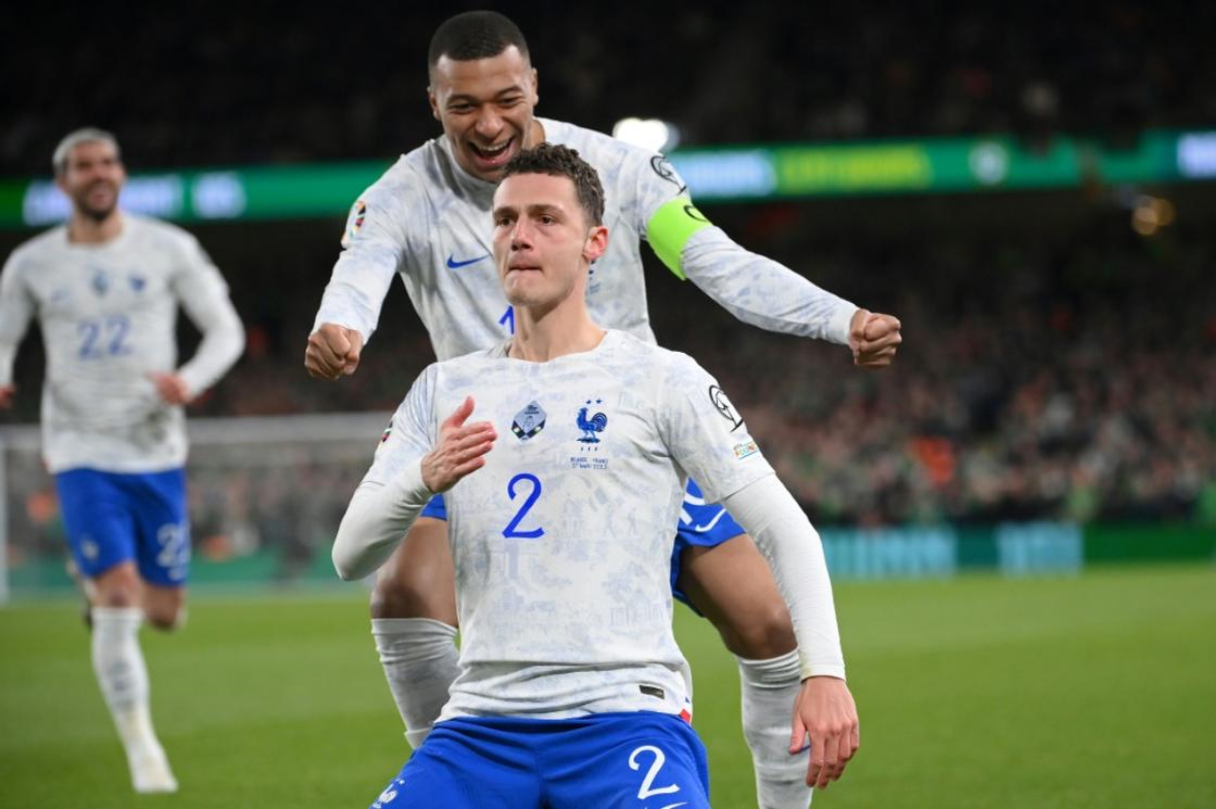 France defender Benjamin Pavard (front) celebrates with captain Kylian Mbappe (behind) after scoring the only goal of a 1-0 Euro 2024 qualifying-win against the Republic of Ireland in Dublin