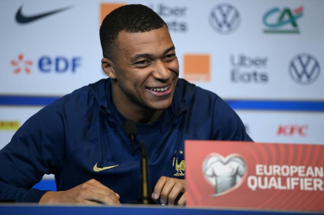 Kylian Mbappe smiles as he speaks to media at the Stade de France on Thursday ahead of France's Euro 2024 qualifier against the Netherlands