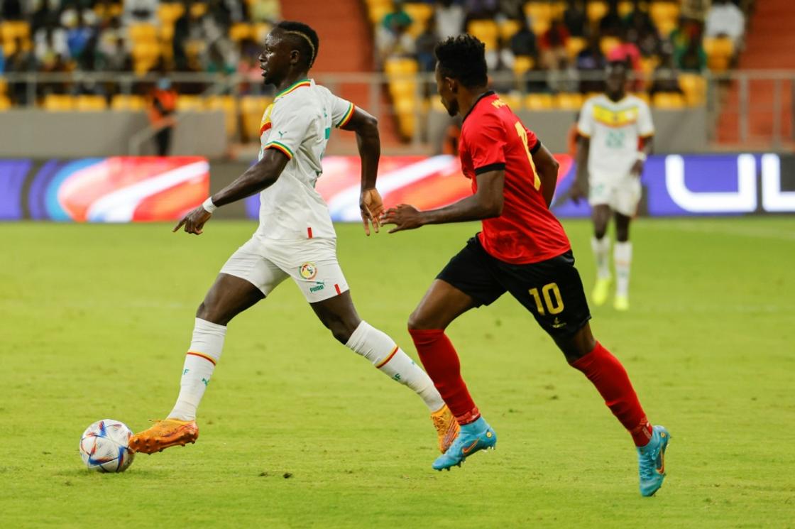 Senegal star Sadio Mane (L) attcks against Mozambique in Dakar.
