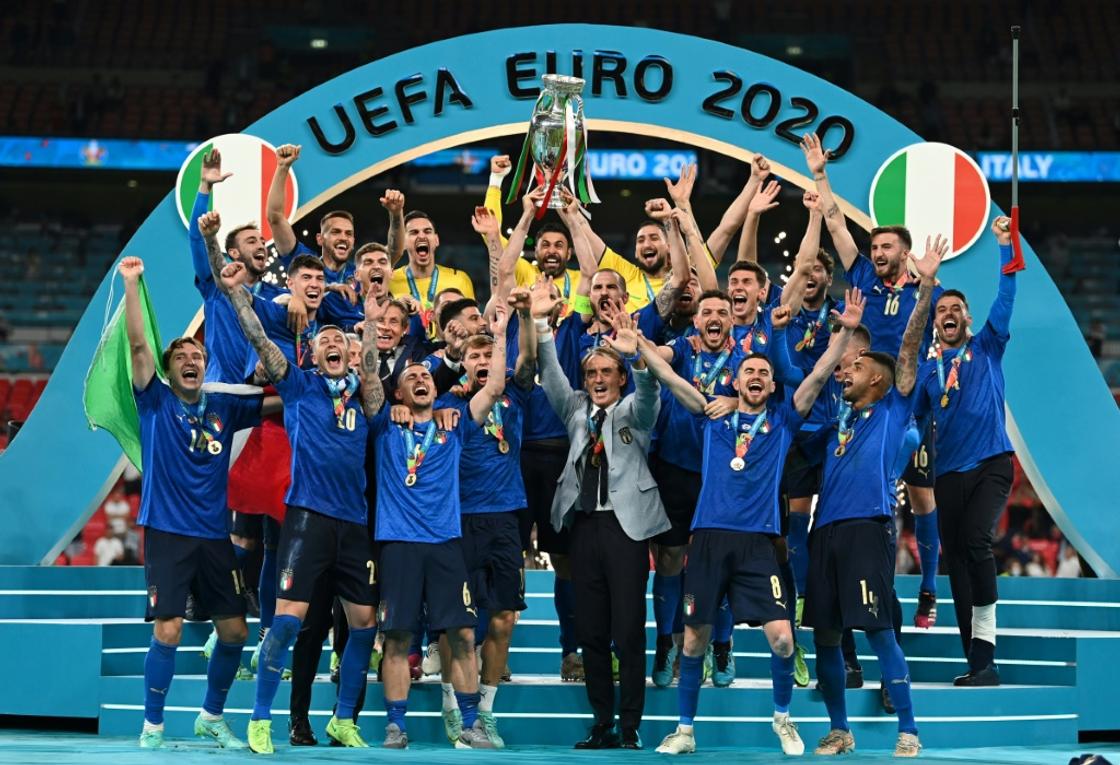 Italy players celebrate with the trophy after beating England in the final of the last European Championship