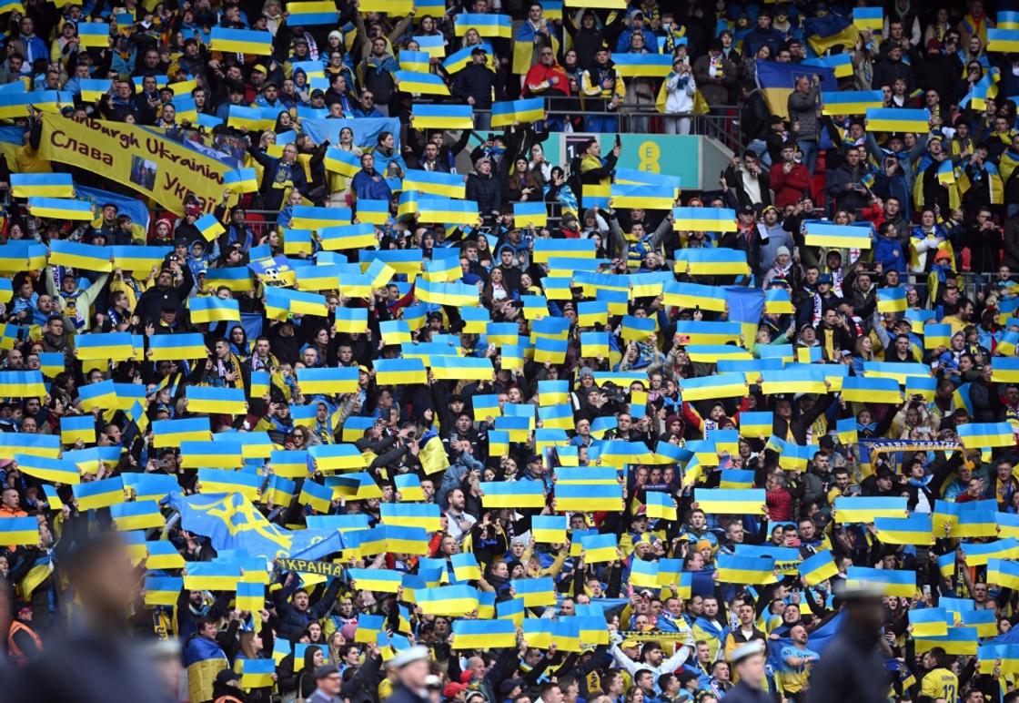 Ukraine supporters hold up flags ahead of the Euro 2024 qualifier against England at Wembley