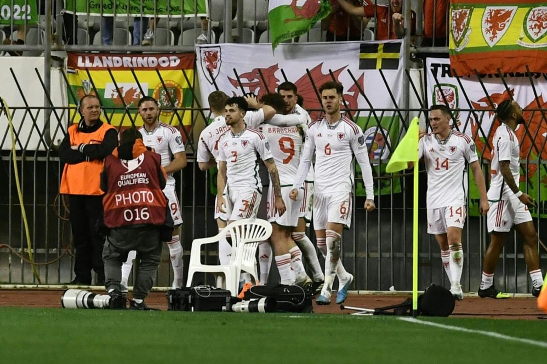 Wales's Nathan Broadhead (C) is congratulated by team-mates after scoring the equaliser during a 1-1 draw away to Croatia in a Euro 2024 qualifier in Split