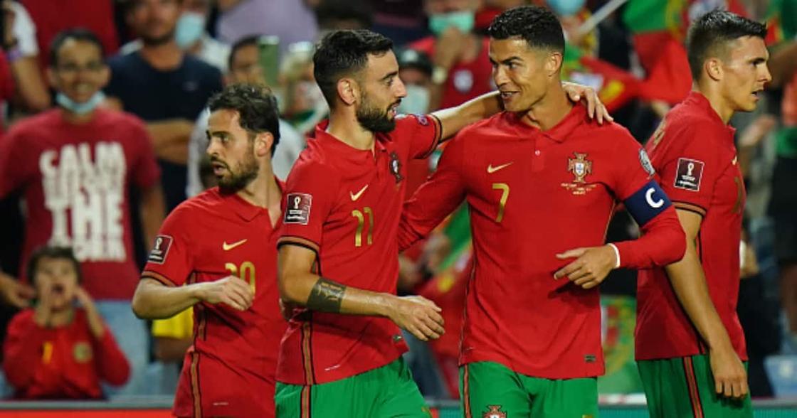 Cristiano Ronaldo celebrates a goal with his Portuguese teammates.