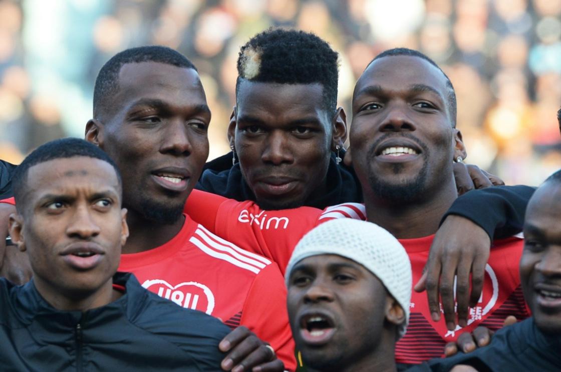 Paul Pogba (centre) flanked by brothers Florentin Pogba (left) and Mathias Pogba (right) ahead of a charity football match in 2019