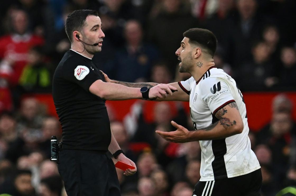 Fulham striker Aleksandar Mitrovic (right) is facing a lengthy ban after pushing referee Chris Kavanagh (left)