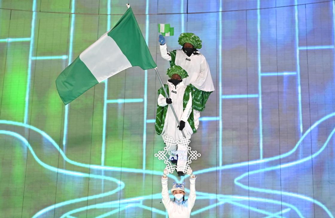 Seun Adigun leads Nigeria out at the 2022 Winter Olympics opening ceremony.