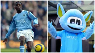Shaun Wright-Phillips with mascot Moonchester in Cape Town showing off Manchester City's silverware