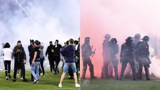 Saint Etienne fans throw flares and explosives at their players after the team is relegated from Ligue 1