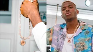 Super Eagles star Osimhen flaunts diamond encrusted chain with photo of late parents on his birthday