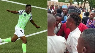 Football fans surround Ahmed Musa in a mosque in Abuja