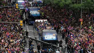 Barca fans celebrate league titles with players in parade