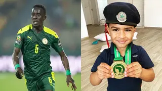 Adorable moment as Senegal star Idrissa Gueye’s son cherishes AFCON medal