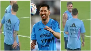 Lionel Messi jokes with teammates by faking an injury during Argentina's public training