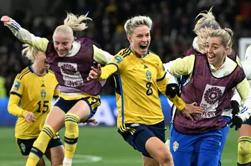 Lina Hurtig (C) celebrates with her teammates after her penalty in the shoot-out against the United States crept over the line, sending the holders crashing out