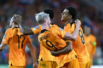 Cody Gakpo (R) celebrates with Wout Weghorst after scoring in the Netherlands' 3-0 win over Greece