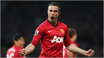 Robin van Persie celebrates scoring the opening goal during the Barclays Premier League match between Manchester United and Aston Villa at Old Trafford. Photo by Alex Livesey.