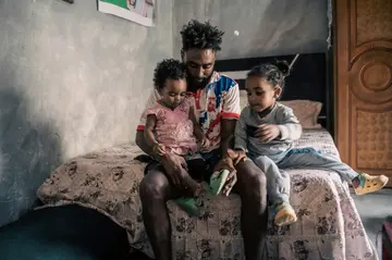 Kibrom Asbeha, pictured with his  daughters, says he suffered many heartbreaking losses in the war