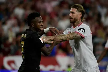 Sevilla defender Sergio Ramos (R) pushes Real Madrid's Vinicius Junior in a tense La Liga draw on Saturday