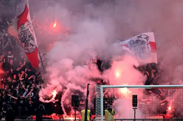 The game was called off on Sunday after Ajax fans threw flares onto the pitch