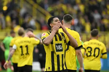 Dortmund midfielder Jude Bellingham shows his appreciation for the home fans during a 6-0 win over Wolfsburg