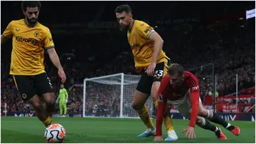 Mason Mount in action with Max Kilman during the Premier League match between Manchester United and Wolves at Old Trafford. Photo by Matthew Peters.