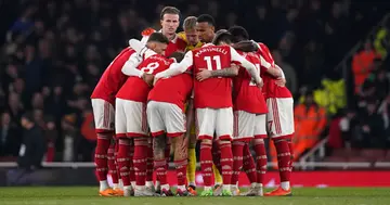 Arsenal players in a group huddle before the second half during the Premier League match at the Emirates Stadium. Photo by John Walton.