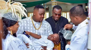Rich ex-Super Eagles Star Stunned As Cubana Chiefpriest Son Gets Baptized in All-White D&G Designer Wear
