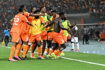 Oumar Diakite (2R) of Ivory Coast takes his shirt off -- which led to him being sent off --as he celebrates scoring the winner against Mali in an Africa Cup of Nations quarter-final