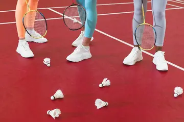 People Holding Badminton Rackets