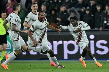 Bayer Leverkusen's Jeremie Frimpong (R) celebrates after scoring against West Ham
