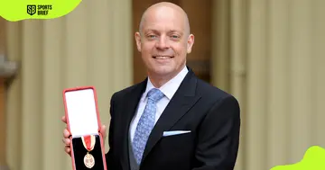 Dave Brailsford poses with an award outside the Buckingham Palace during an Investiture ceremony
