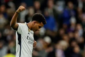 Real Madrid forward Rodrygo celebrates after netting the team's second against Granada as his club caught Girona at the top of La Liga