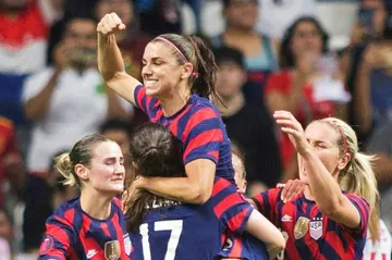 United States striker Alex Morgan raises her fist as she his hoisted into the air to celebrate her penalty shot goal that delivered the Americans a 1-0 victory over Canada in the CONCACAF W Championship final and a berth in the 2024 Paris Olympics