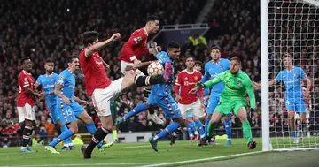 Cristiano Ronaldo and Harry Maguire of Manchester United in action during the UEFA Champions League Round Of Sixteen match at Old Trafford on March 15, 2022 in Manchester, England. (Photo by Tom Purslow/Manchester United via Getty Images)