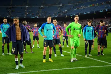 Barcelona's players face their supporters after they were eliminated at the Champions League group stage for the second consecutive year