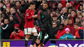 Lisandro Martinez leaves the game after picking up an injury during the Premier League match at Old Trafford. Photo by Martin Rickett.