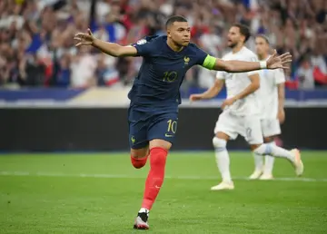 Kylian Mbappe runs away in celebration after scoring France's winner against Greece from the penalty spot