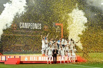 Real Madrid's players and coach Carlo Ancelotti celebrate with the King's Cup trophy at the end of the Spanish Copa del Rey (King's Cup) final