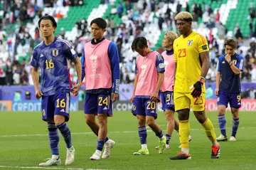 Japan's players leave the pitch after losing to Iran
