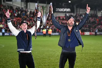 US actors Rob McElhenney (left) and Ryan Reynolds (right) celebrate Wrexham's National League triumph last season