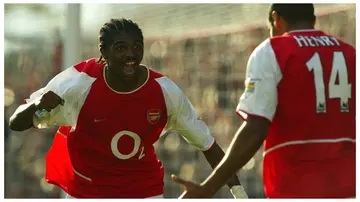 Former Arsenal striker Nwankwo Kanu celebrates a goal with Thierry Henry in 2002. Photo: Ben Radford.