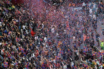 Thousands of fans filled the city's streets to greet the two title winning Barcelona teams