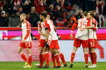 Bayern Munich forward Harry Kane said his side will "never give up" despite being eight points behind leaders Bayer Leverkusen in the Bundesliga