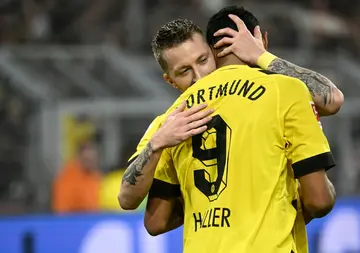 Dortmund forward Sebastien Haller celebrates with captain Marco Reus, both of whom scored twice in their 6-1 win over Cologne on Saturday