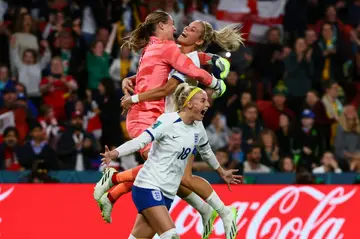 England players celebrate after defeating Nigeria on penalties in Brisbane to reach the Women's World Cup quarter-finals