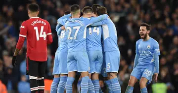 Riyad Mahrez celebrates with teammates after scoring their fourth goal during the English Premier League football match between Manchester City and Manchester United at the Etihad Stadium. (Photo by Oli SCARFF / AFP)
