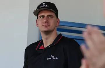 Nikola Jokić in a black polo shirt