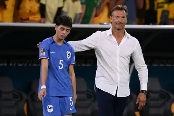 France coach Herve Renard consoles Elisa De Almeida after his team's penalty shoot-out defeat against Australia