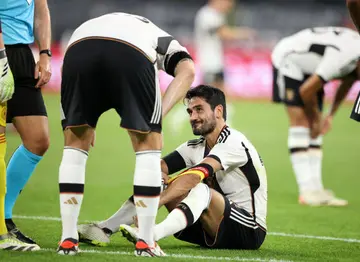A tearful Ilkay Gundogan is consoled by his Germany teammates after he was injured in the friendly against France on September 12 at Signal Iduna Park in Dortmund, Germany...